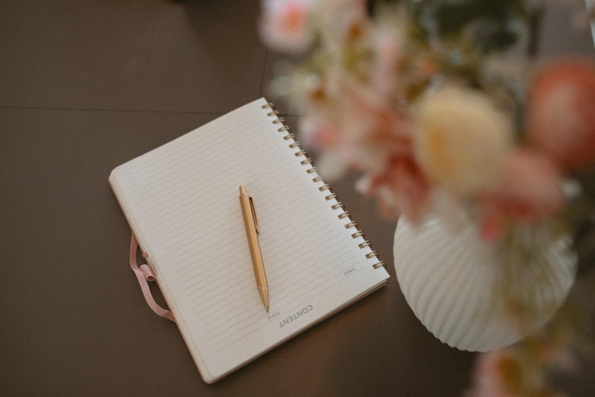 A quiet desk with a notebook and pen at Anchor & Bloom, where single fathers find support