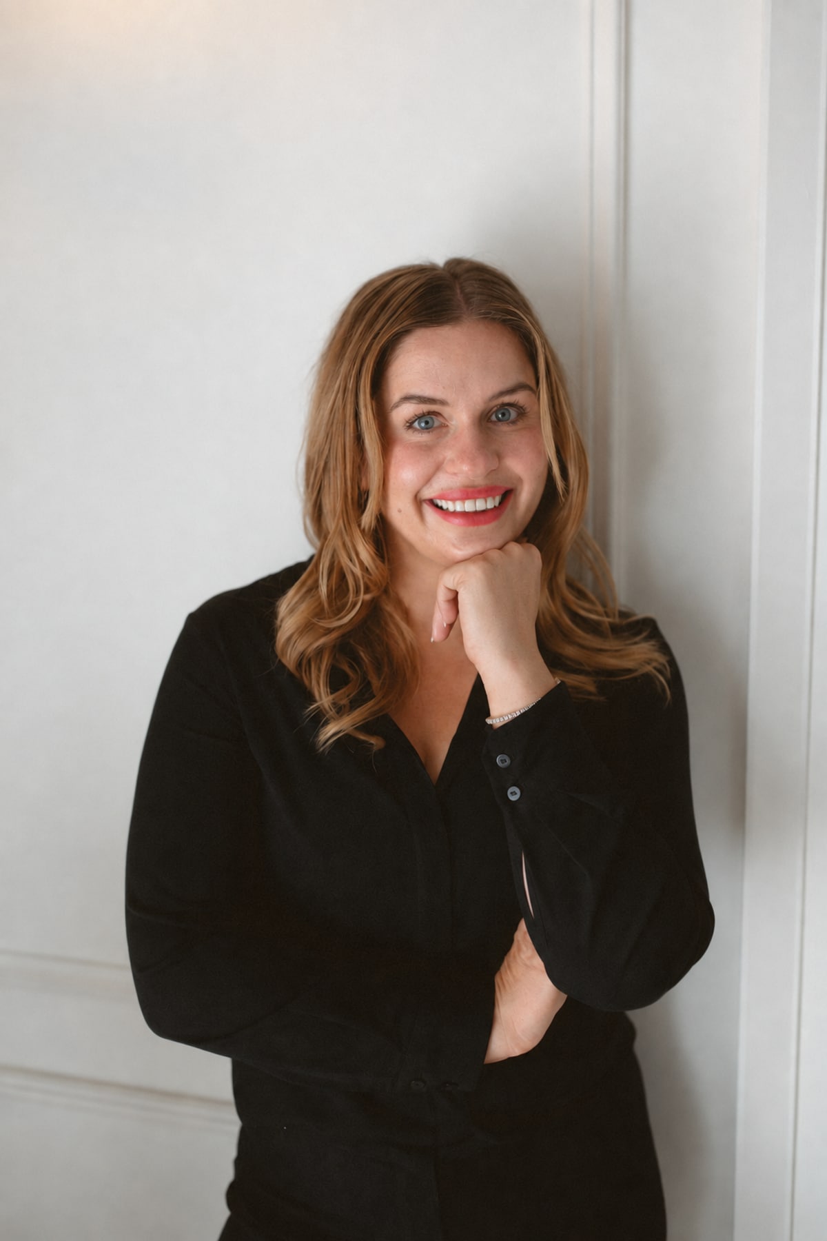 Kristen Lawrynowycz smiling with her chin resting on her hand