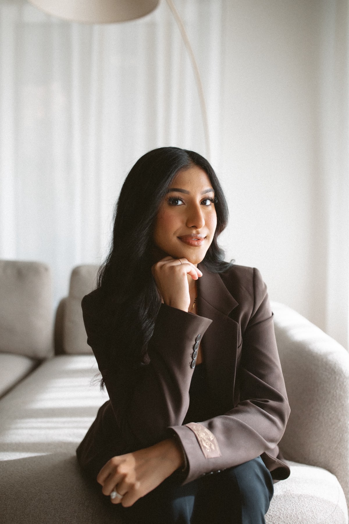 Mahima Chauhan seated with her chin resting on her hand