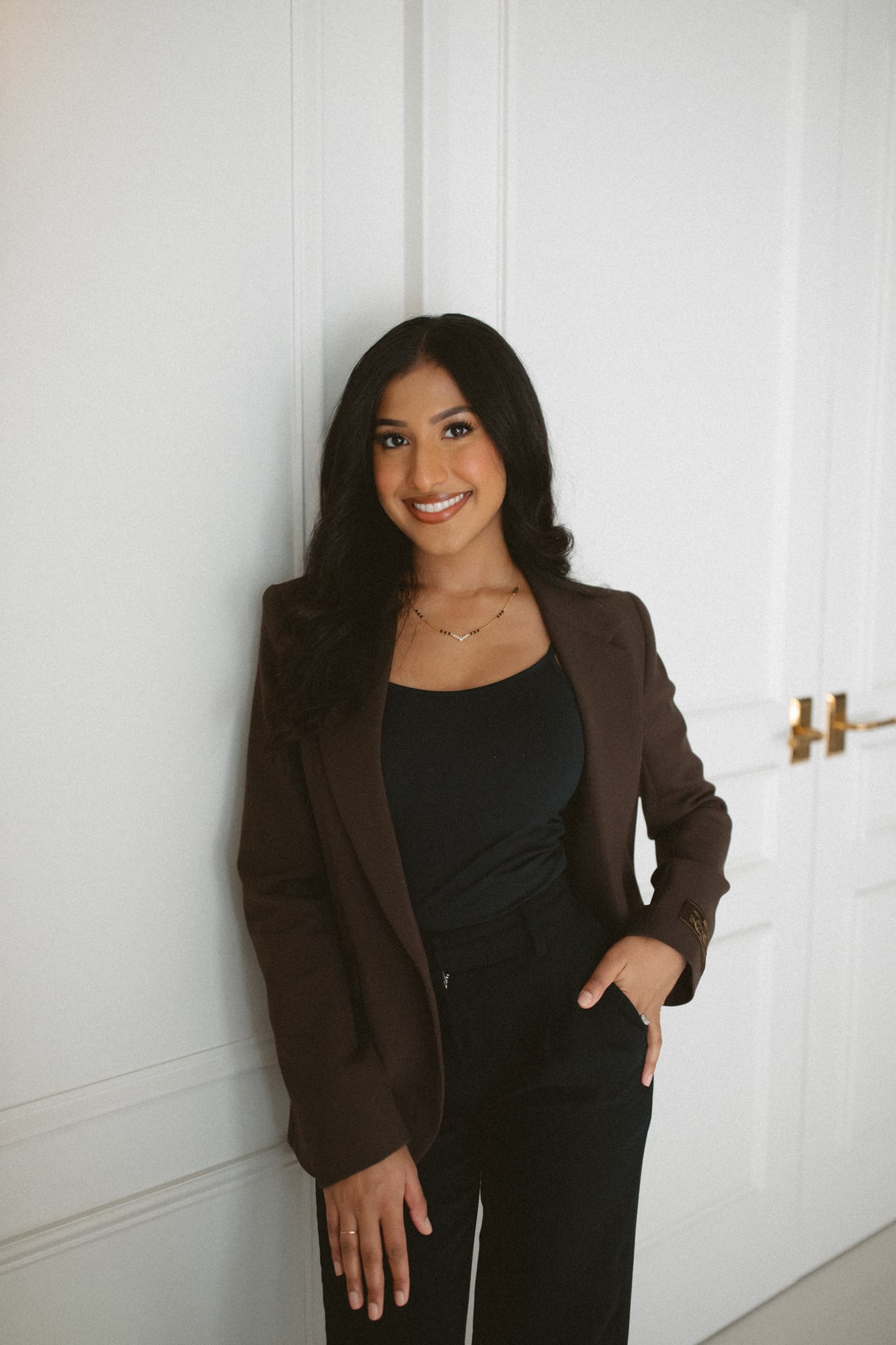 Mahima Chauhan standing beside a panelled wall