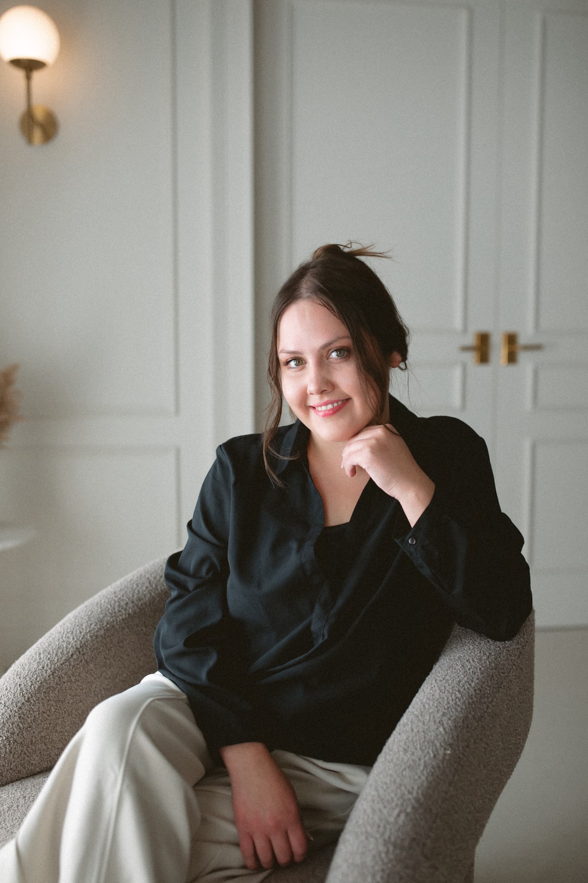 Megan Harvey smiling while seated in an armchair
