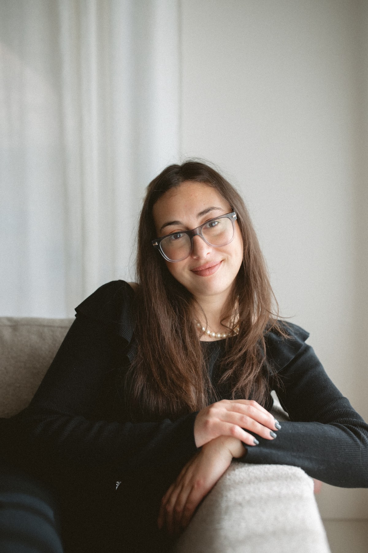 Natalie Besharat resting her hands on a chair