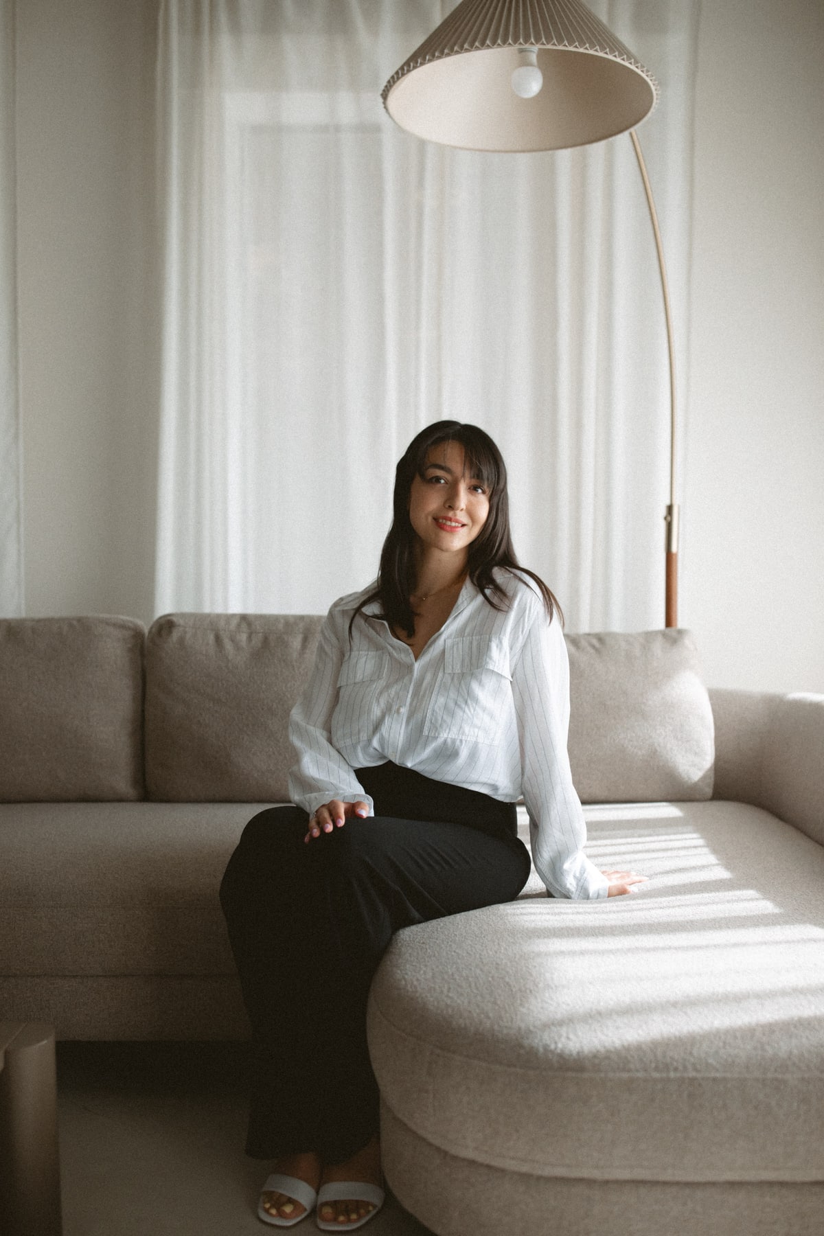 Rashin Heydari-Alamdari seated on a sofa