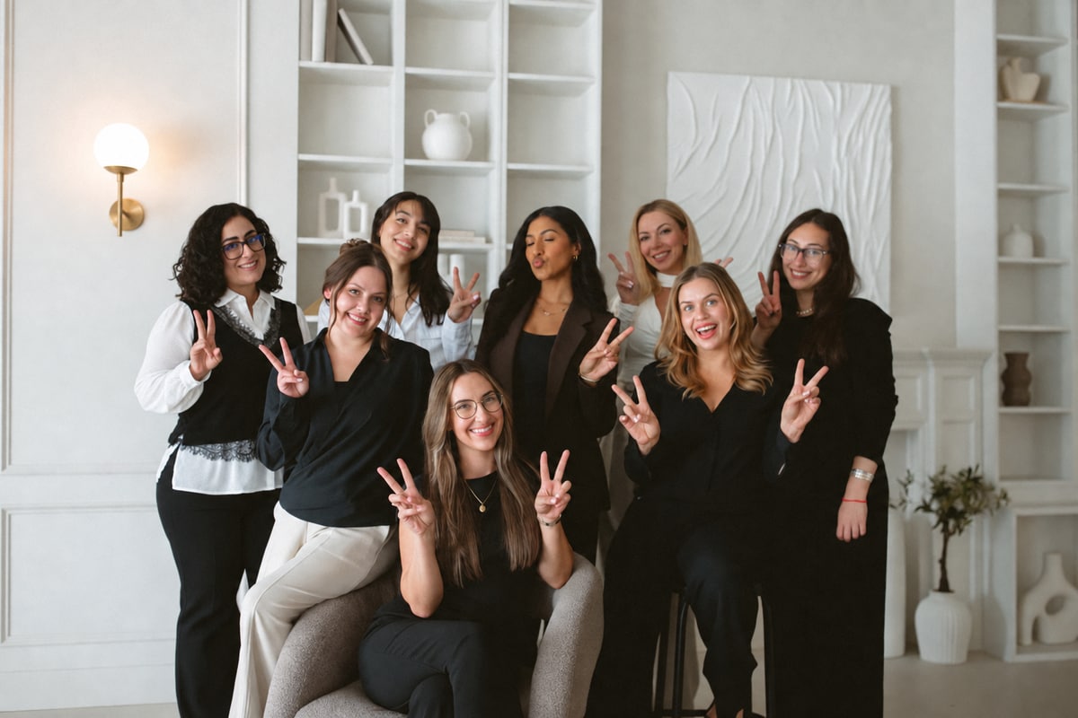 Anchor & Bloom team smiling and making peace signs during a group photo